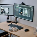 black flat screen computer monitor on brown wooden desk