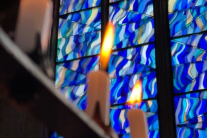 close up photo of candles on black metal frame